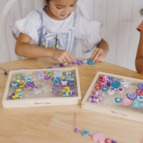 Melissa & Doug Sweet Hearts and Butterfly Friends bead set child strings beads to improve fine motor skills