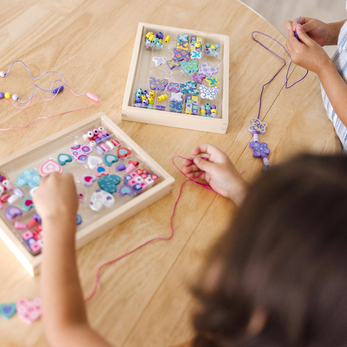 Patterning and design play with Melissa & Doug bead set featuring heart and butterfly themes