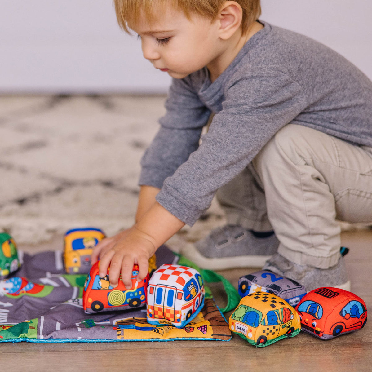 Melissa & Doug Take-Along Town Play Mat bases show numbers for early recognition.