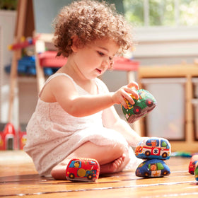 Melissa & Doug Take-Along Town Play Mat soft vehicles array for tactile exploration.