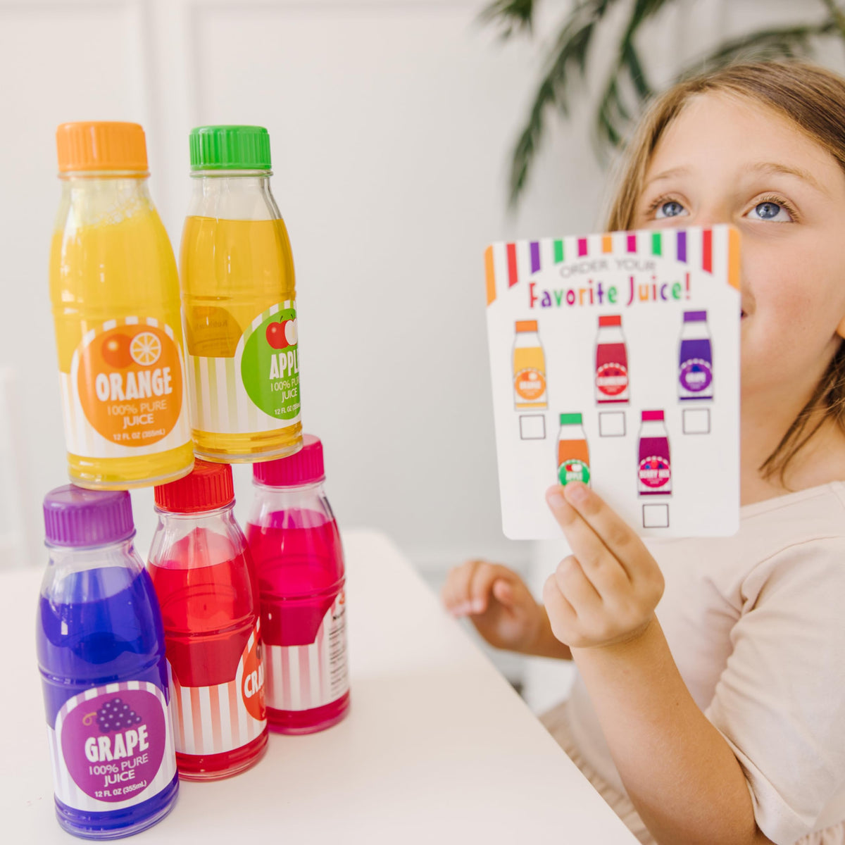 Melissa & Doug Tip & Sip orange bottle pour encourages storytelling and fine motor skills.