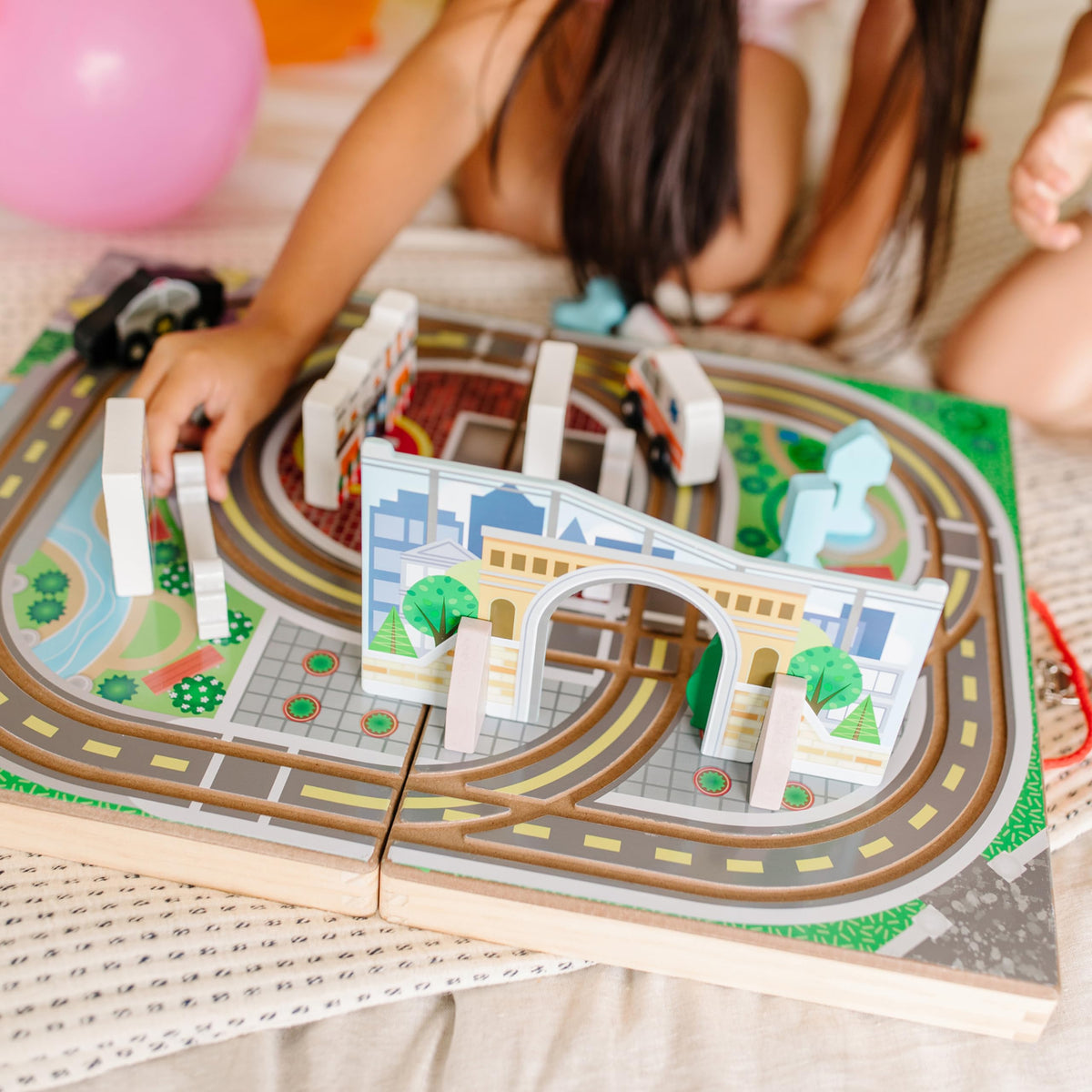 Melissa and Doug town play surface unfolds to reveal built-in road tracks for vehicles