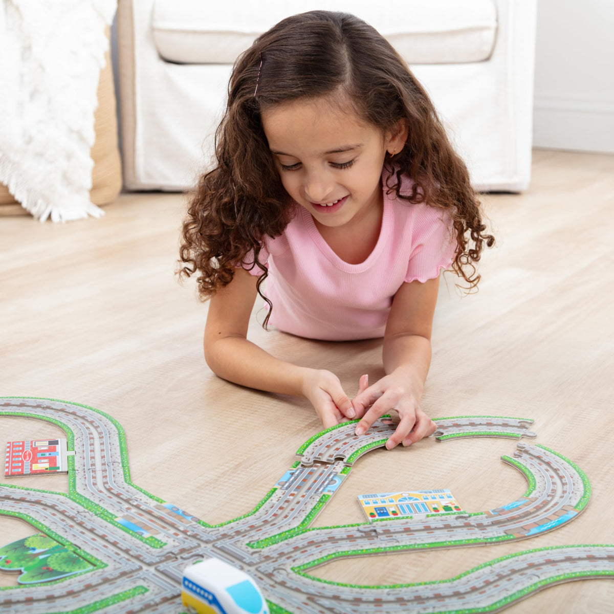 Melissa & Doug wind-up locomotive train ready to race along custom rails for active learning