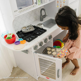 Melissa & Doug wooden chef’s kitchen sink with moving faucet for splashy pretend tasks.