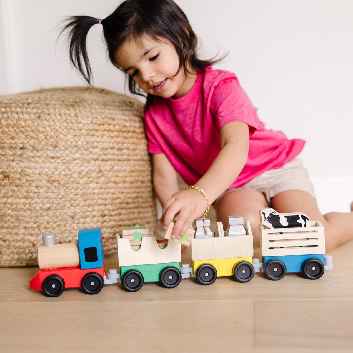 Melissa & Doug wooden farm train car 2 with interchangeable cargo fosters counting practice.