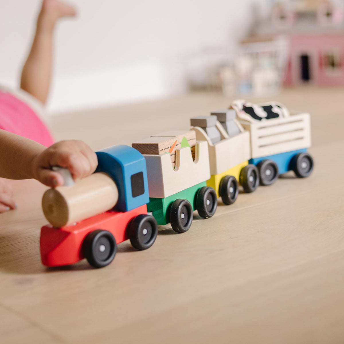 Melissa & Doug wooden farm train cow—friendly figure enhances pretend farm themes.