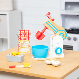 Melissa and Doug wooden make-a-cake mixer set wooden knife for safe pretend cutting.