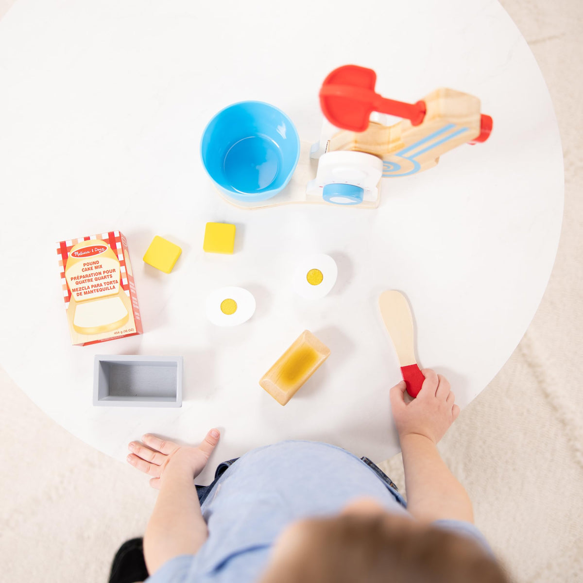 Melissa and Doug wooden make-a-cake mixer set pretend cake mix box sparks creativity.