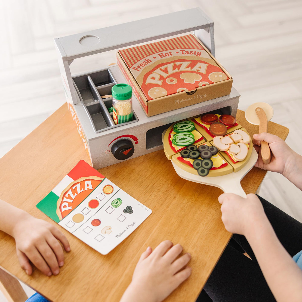 Melissa & Doug wooden pizza cutter and rolling cutter ready for slicing pretend pies.