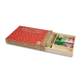 Melissa & Doug wooden town picket fence supports stacked play moments.