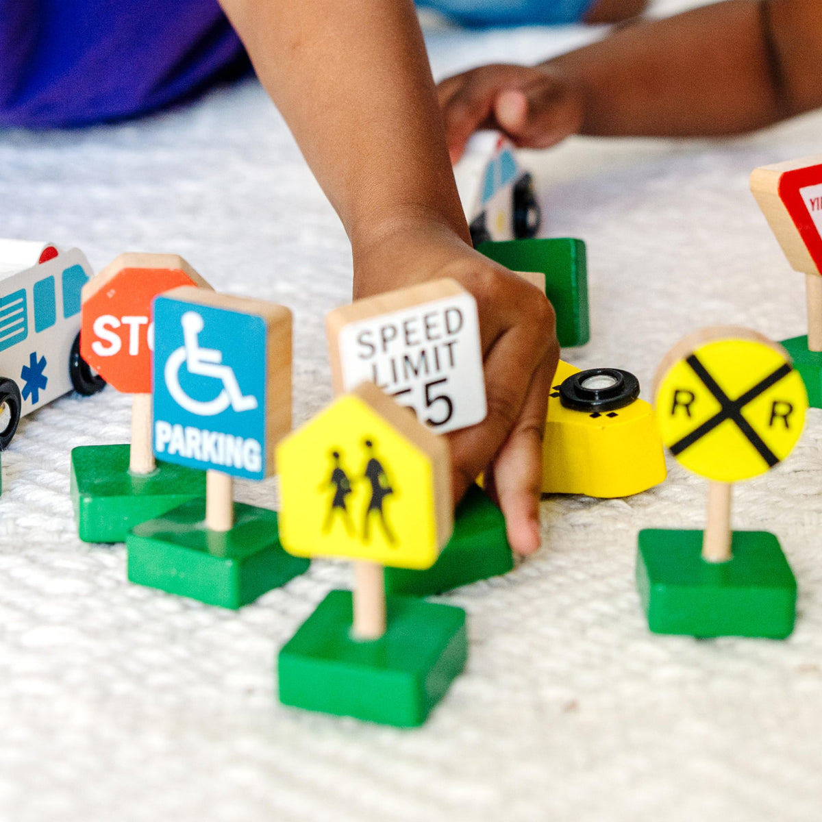 Melissa & Doug wooden passenger car promotes social play and color matching.