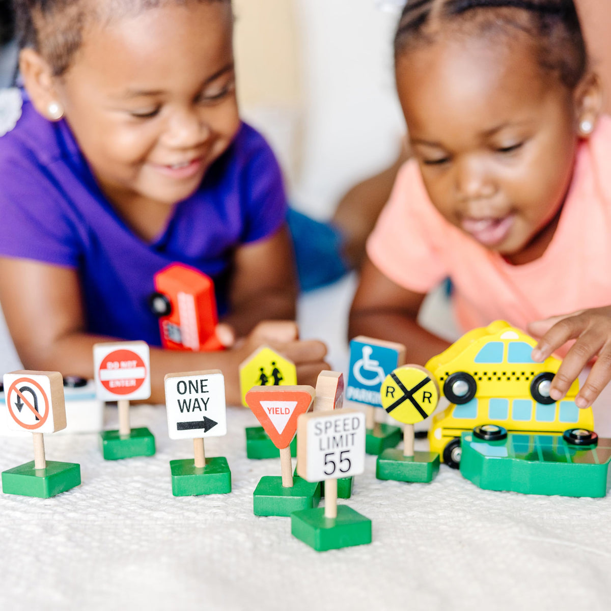 Melissa & Doug wooden taxi supports pretend driving and fine motor practice.