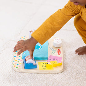 Melissa & Doug wooden desk activity board reveals peekaboo mirror for social engagement.
