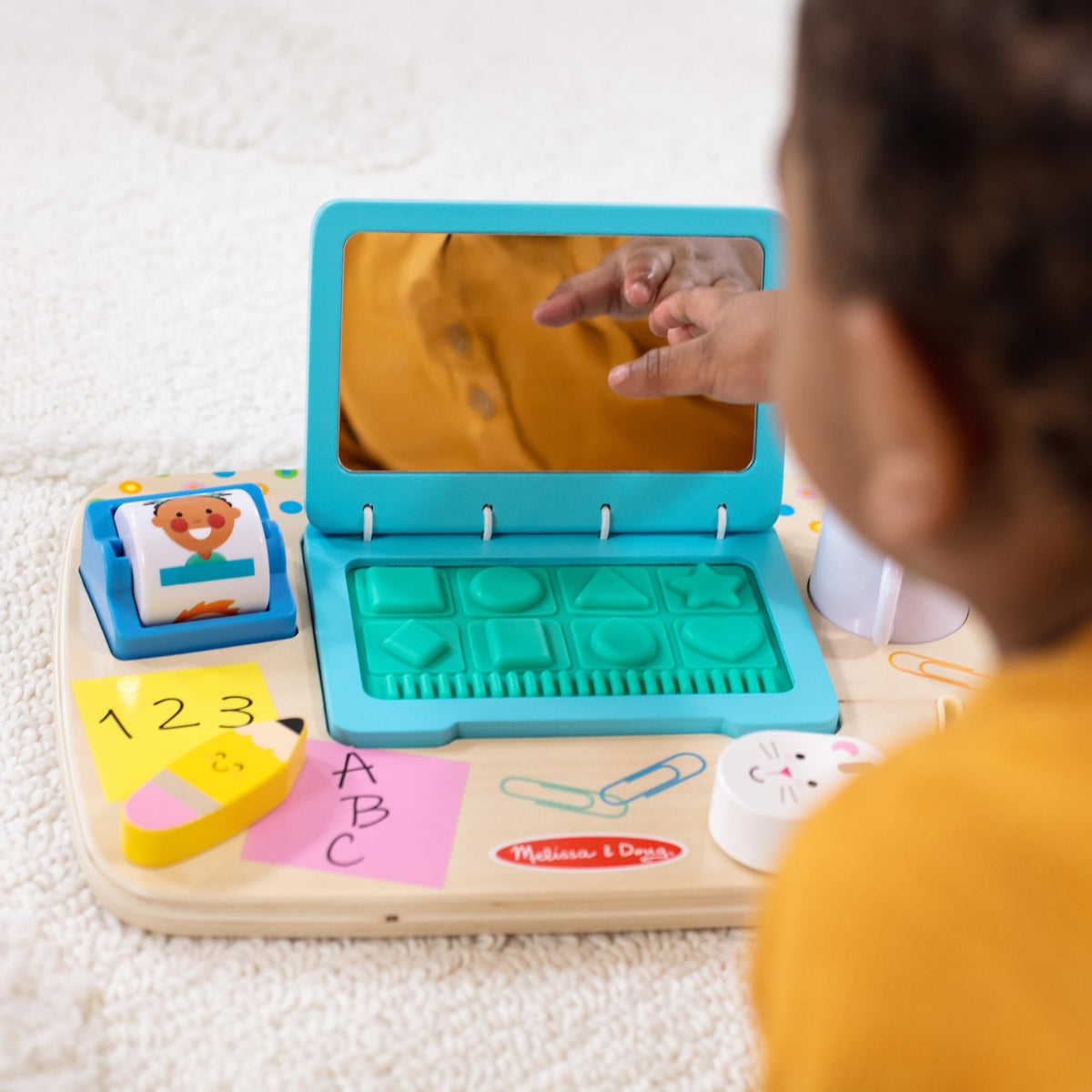 Melissa & Doug board with rubberized keyboard buttons to touch and press for shape recognition.