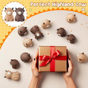 Meooeck Highland Cow stress balls on a desk offering portable stress relief and decor