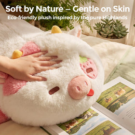 Mewaii weighted strawberry cow plush on bed as a cozy nighttime companion.