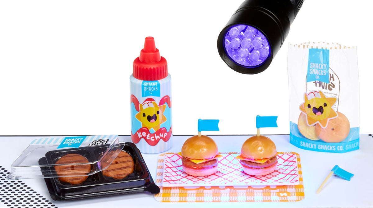 MGA's Miniverse display capsule showcases finished resin miniatures under UV light.