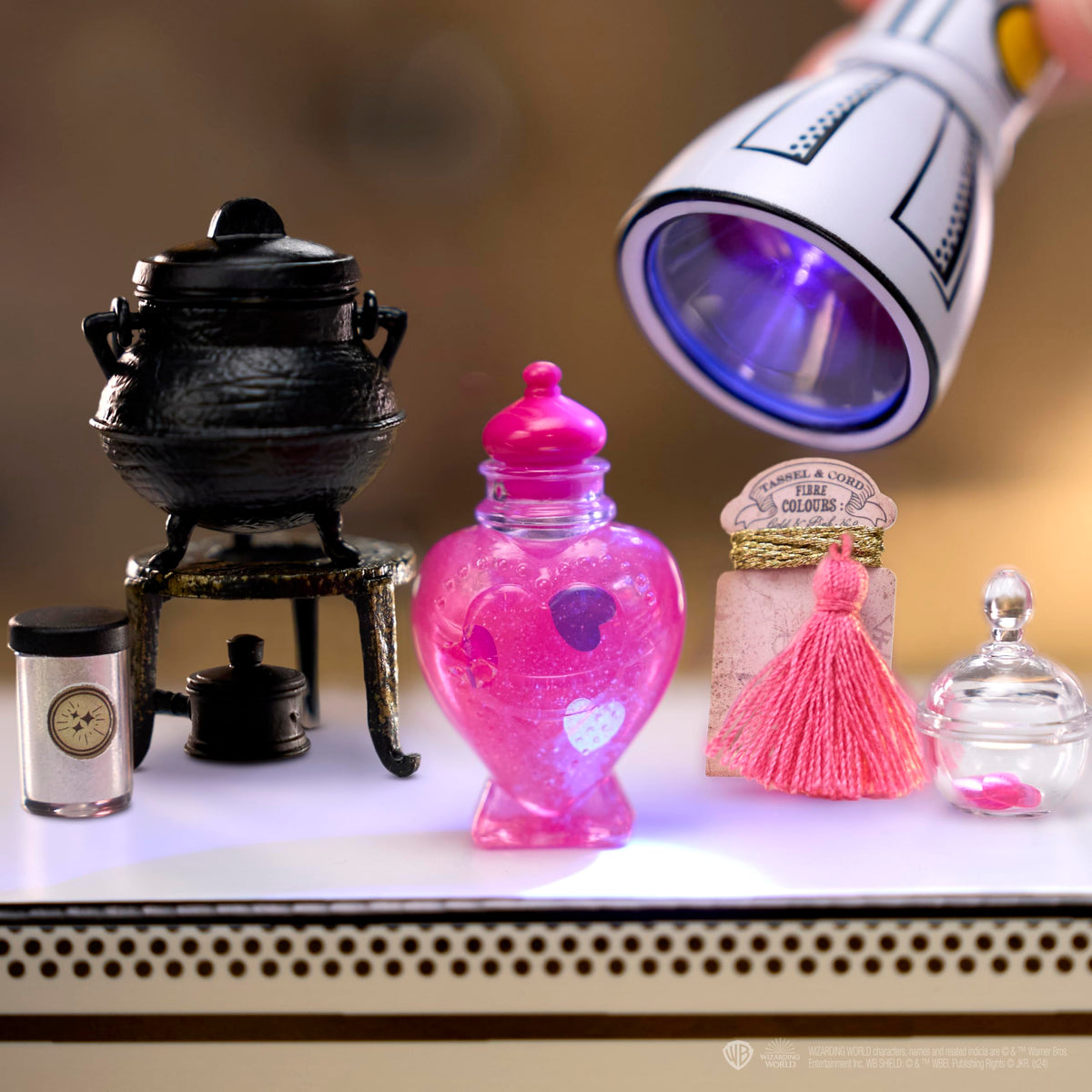 Display-ready ball transforms into a miniature potion bottle stand.