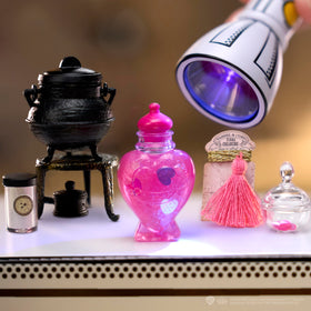 Display-ready ball transforms into a miniature potion bottle stand.