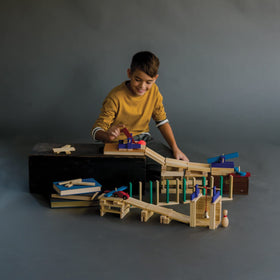 MindWare KEVA Contraptions ball-run display showing marble-driven paths and cause-and-effect play.