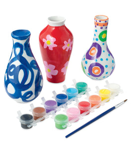 MindWare Paint Your Own Vases hands painting porcelain vase during a craft session.