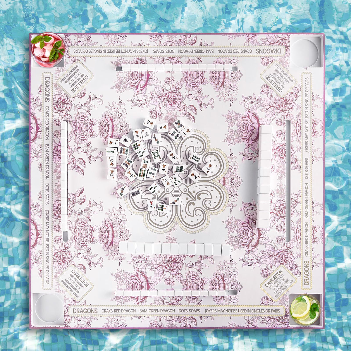 MinFyberd floating Mahjong table in a pink-accent pool setting.