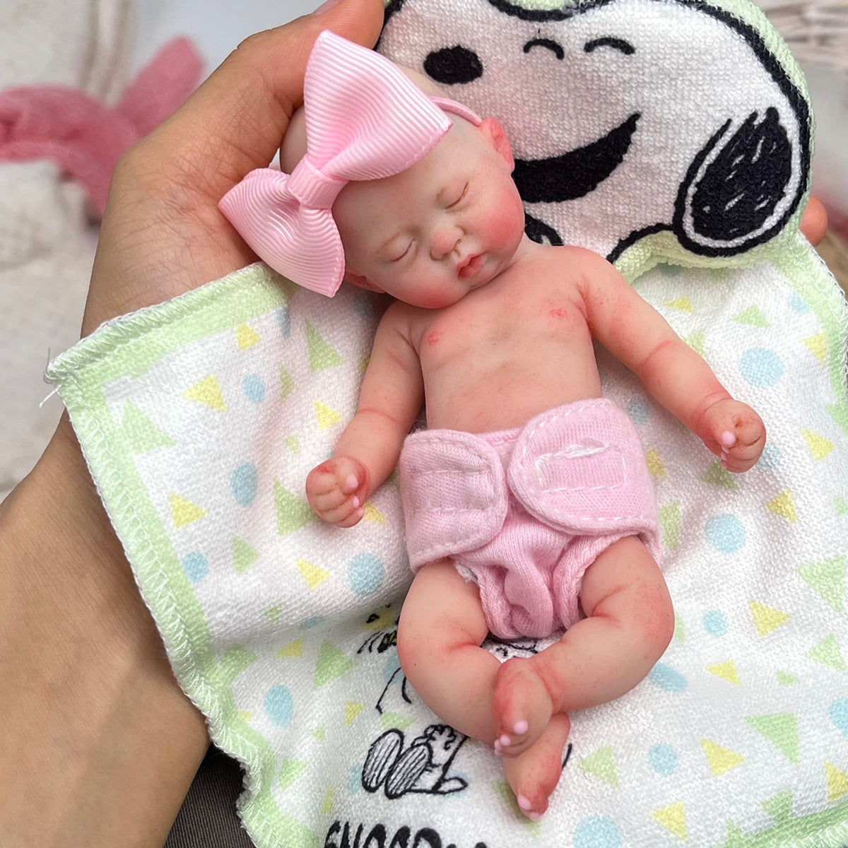Mire and Mire hand-painted details highlight charming baby features.