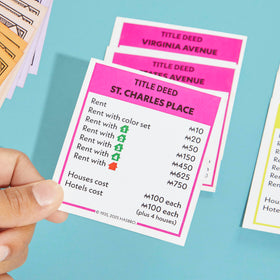 Monopoly components close-up showcases cards and pieces for strategy.