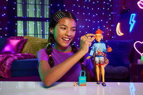 Monster High Heath Burns doll in flame-themed board shorts for seaside fun.