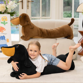 Moris-Mos dachshund plush resting on a bed used as a pillow