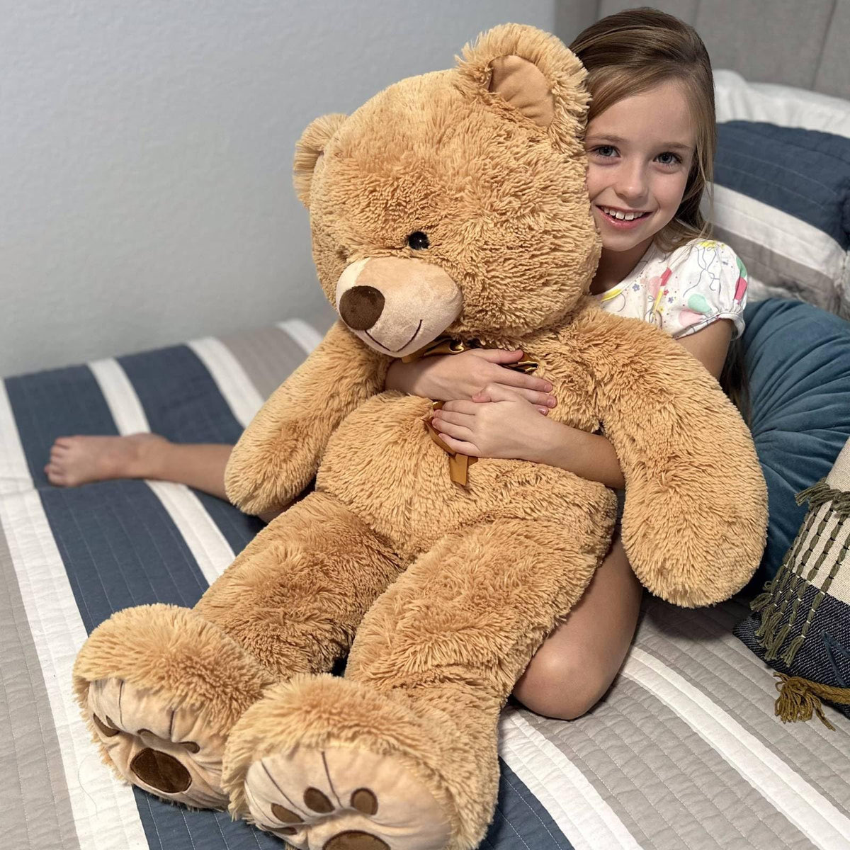 MorisMos 36in giant teddy bear features durable stitching and safety eyes for long-lasting use.