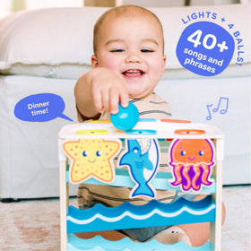 Move2Play Wooden Ocean Friends ball drop demonstrating fine motor exploration.