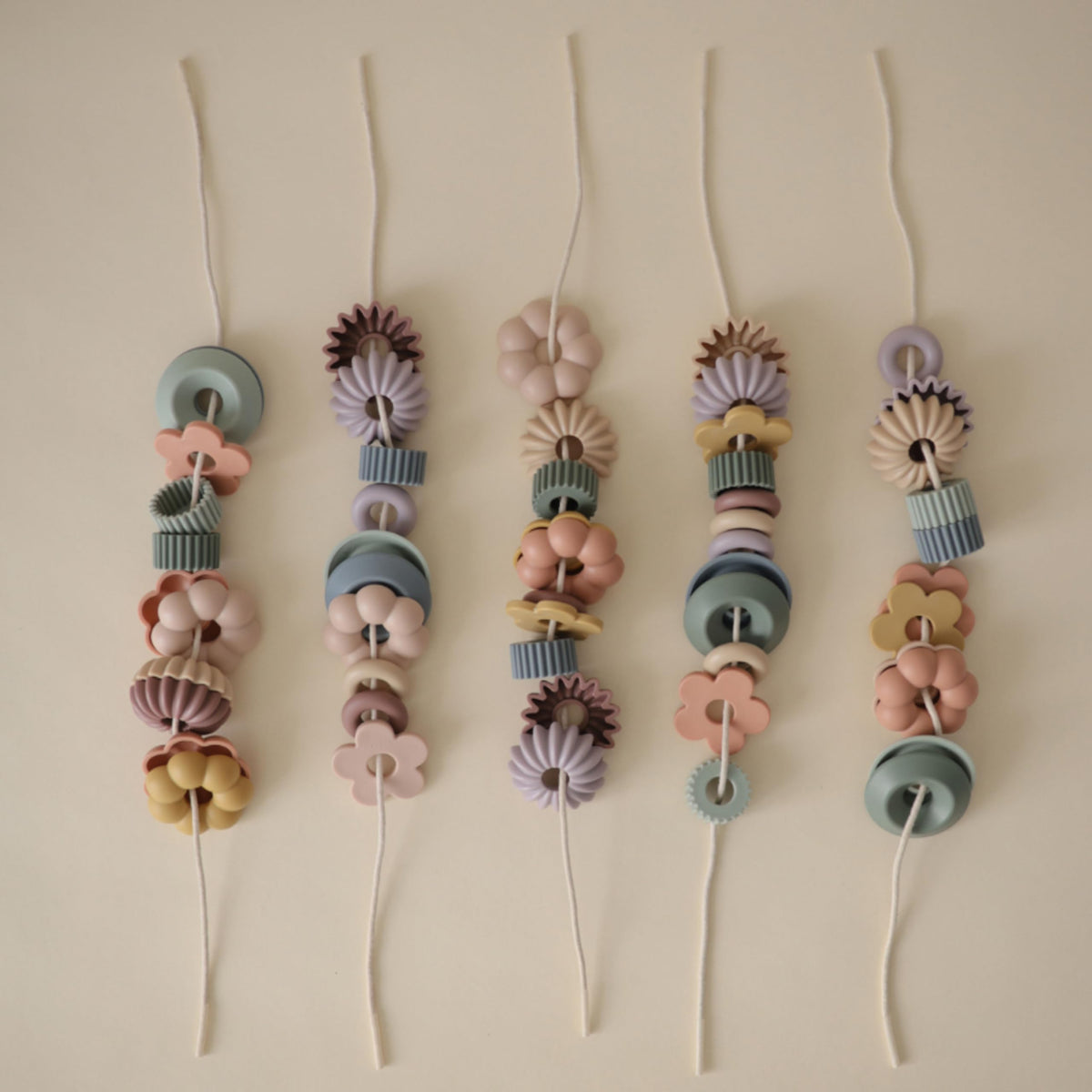 Mushie Bead Lacing Toy Set four strings for easy threading.