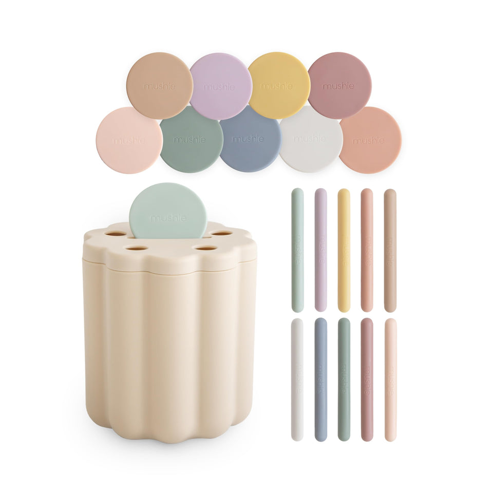 Mushie Coin & Tube Sorting Set – colorful coins and tubes sorted to develop fine motor skills.