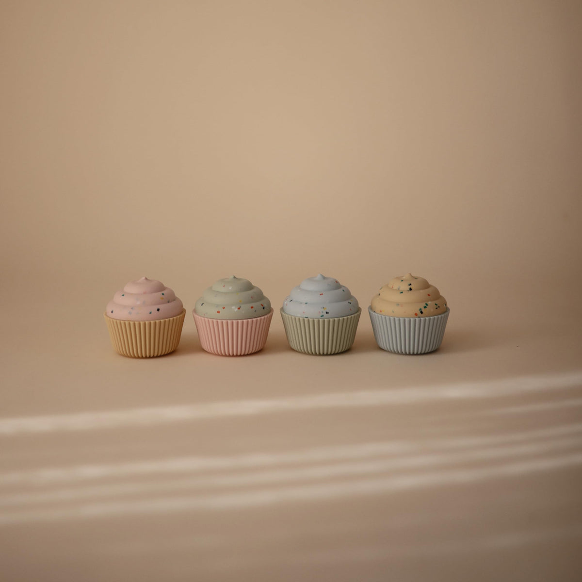 Mushie cupcake toy with stackable pieces promotes fine motor skills and color recognition