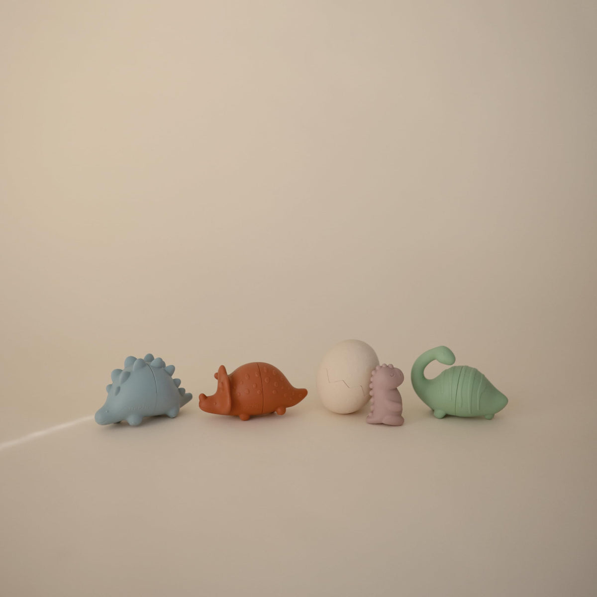 Mushie Dino bath toy egg with baby dino for curious discovery.