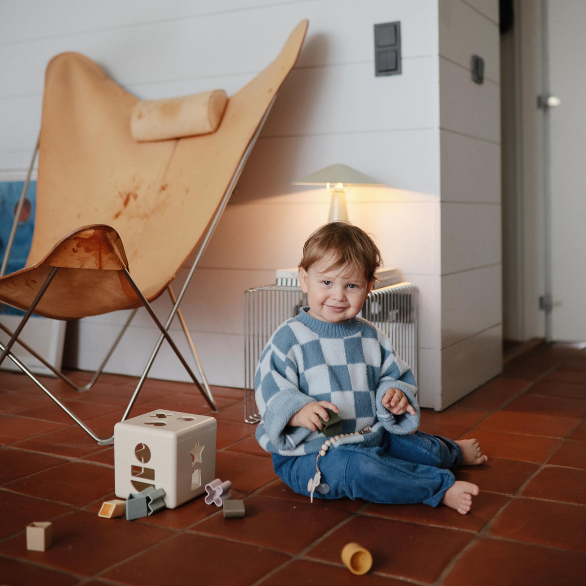 Mushie Shape Sorting Box stackable setup demonstrates nestable shapes for easy storage.