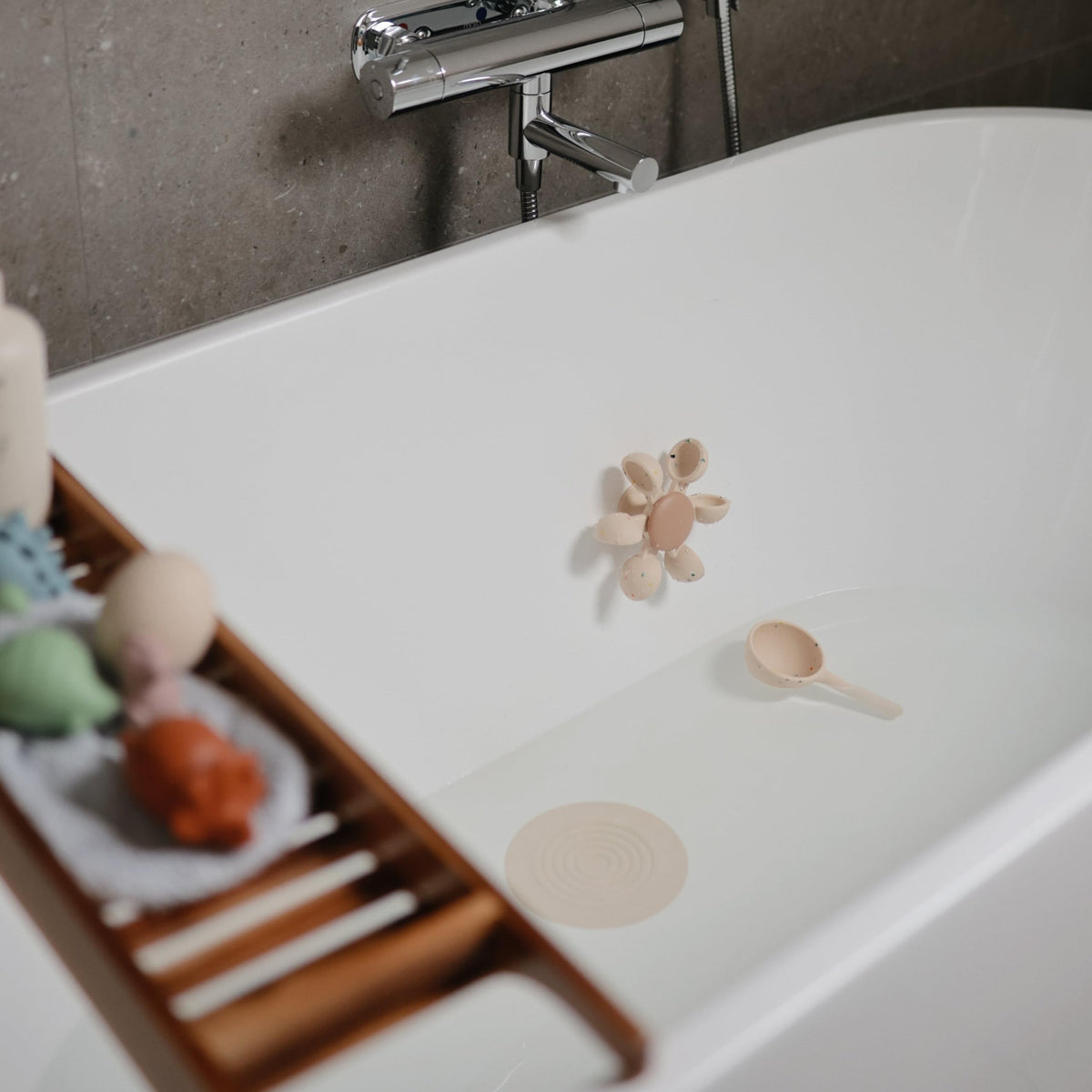 Mushie soft silicone design offers safe, easy cleaning during bath play.