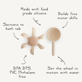 Mushie bath toy attaches to tub wall for hands-free bath time fun.