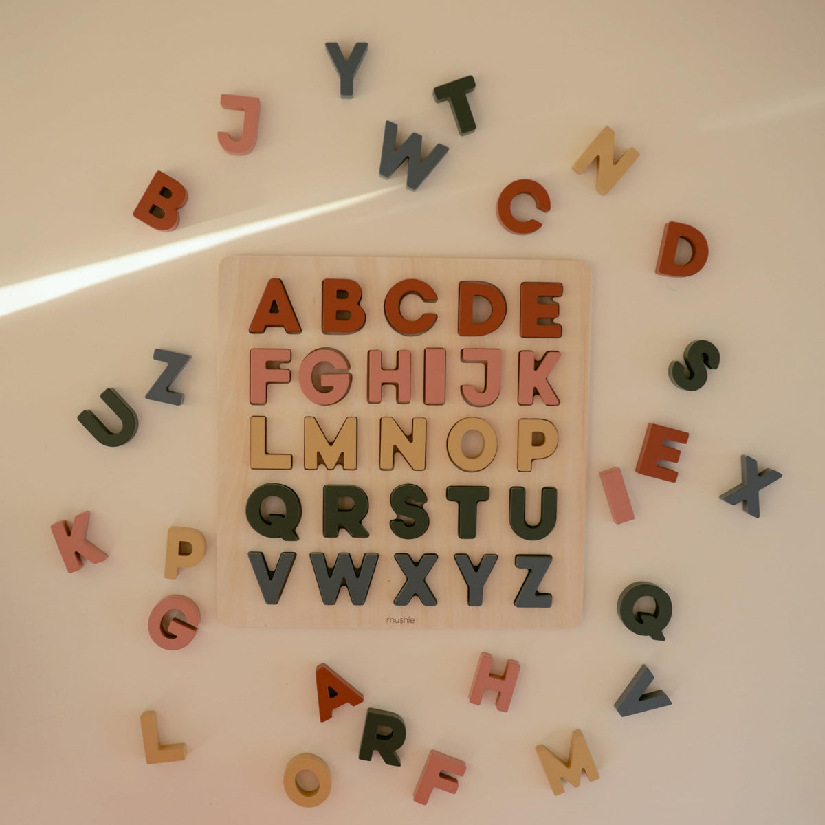 Mushie wooden alphabet puzzle pieces fit securely for precise placement