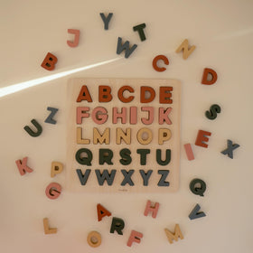 Mushie wooden alphabet puzzle pieces fit securely for precise placement