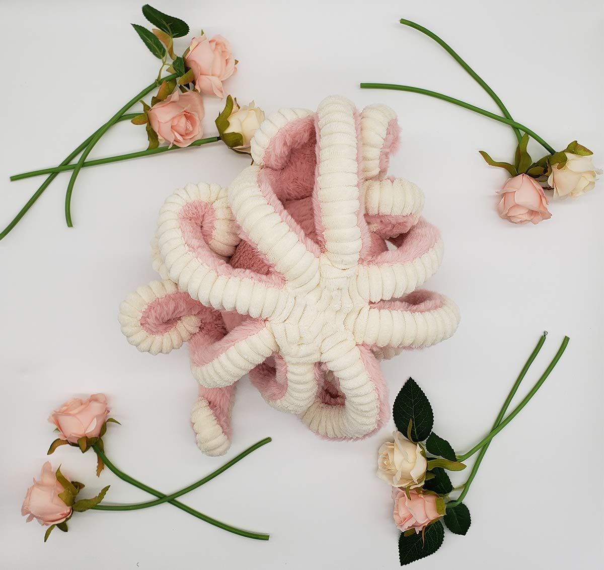 My Super Star pink octopus plush being fluffed to restore fullness.