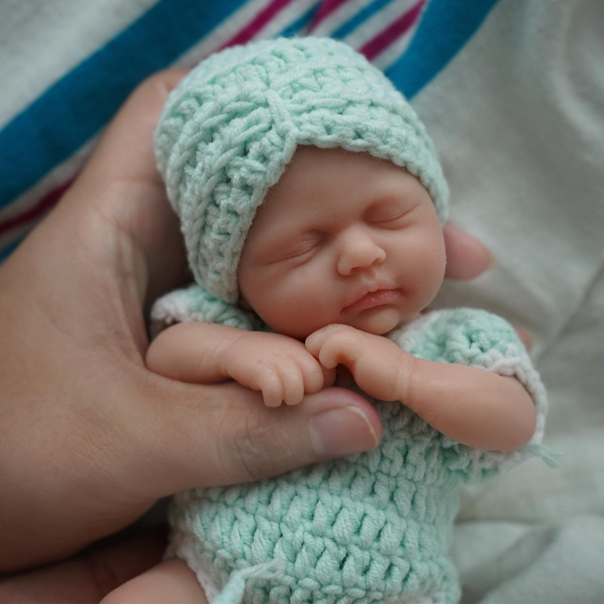 MYREBABY Reborn doll body shot highlighting palm-sized portability for calm on the go