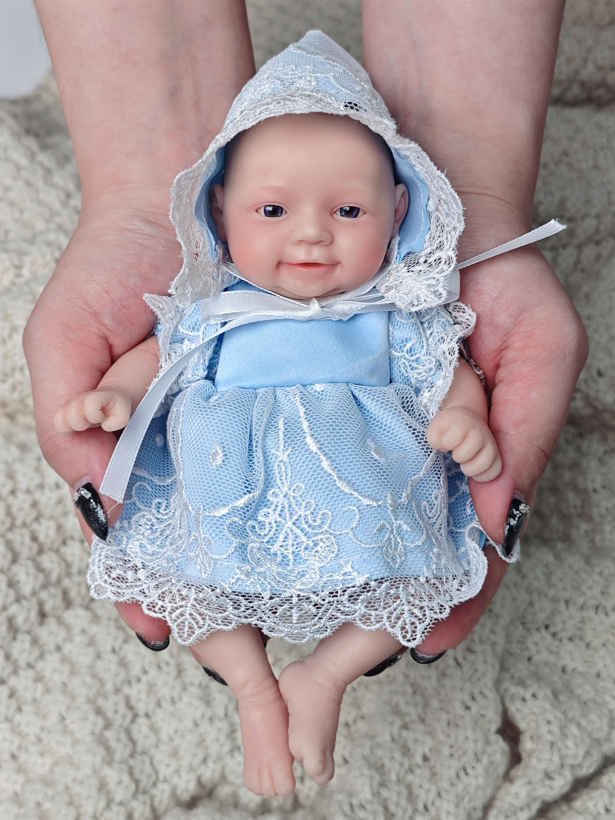 MYREBABY silicone full-body doll close-up shows realistic skin texture.