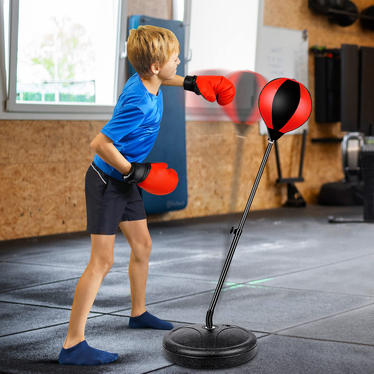NATGGZ kids playing with punching bag shows energetic outdoor activity and focus.