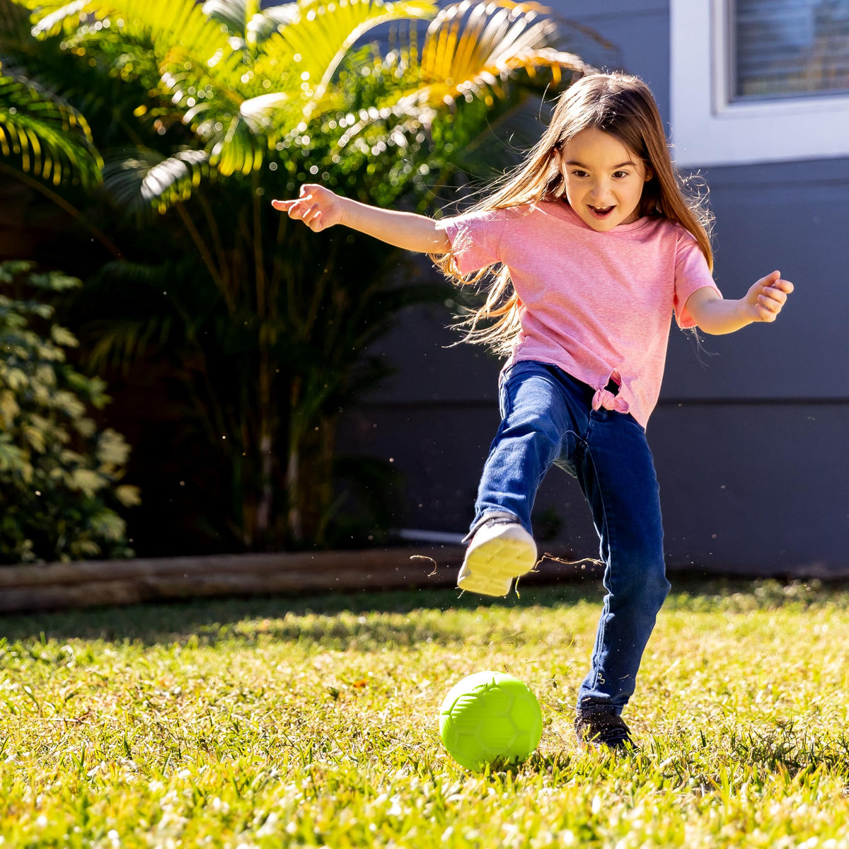 NERF kids playing outdoors with foam balls under sunshine