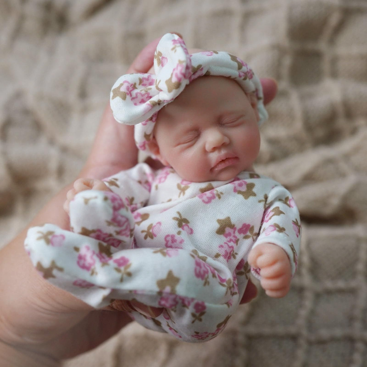 Newtotlove mini silicone baby body close-up emphasizes soft skin feel and realism