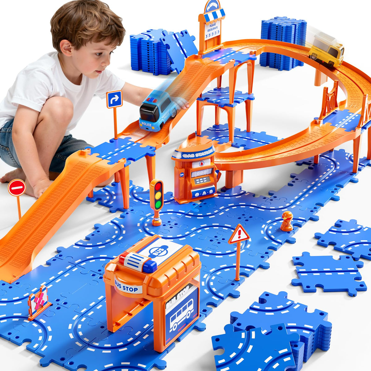 NIPLOOOW Puzzle Race Car Track Set on the floor showing colorful puzzle tracks and two cars for play