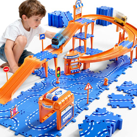 NIPLOOOW Puzzle Race Car Track Set on the floor showing colorful puzzle tracks and two cars for play