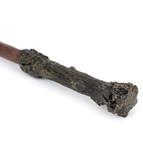 The wand on display in a case with Noble Collection branding.